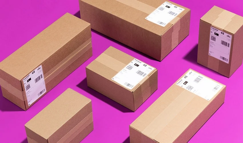 Plain cardboard packaging examples with courier labels on a purple background.