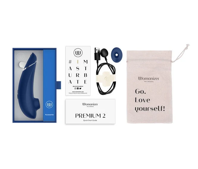 Womanizer Premium 2 product kit with cable, spare head, guide and storage pouch.