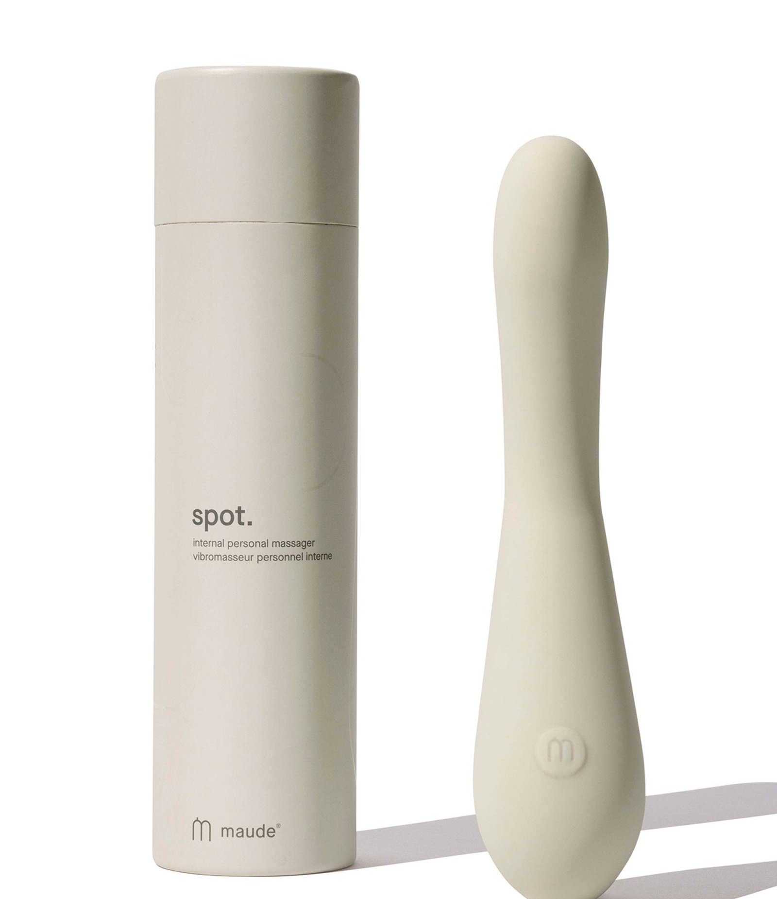 Authentic photograph of the Maude Spot vibrator standing alongside its minimalist cylinder packaging tube box